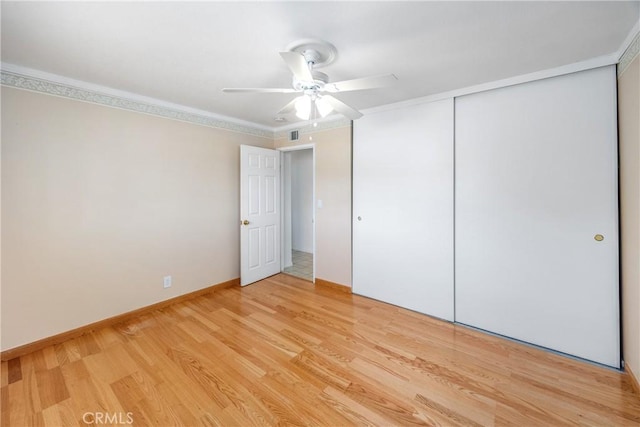 16048 Wintun Rd, Apple Valley, CA 92307 - unfurnished bedroom featuring light wood-type flooring, a closet, ornamental molding, and a ceiling fan