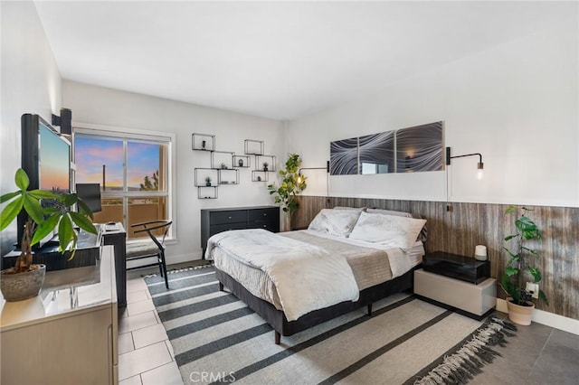 1131 Alta Loma Rd Unit 207, West Hollywood, CA 90069 - bedroom with tile patterned flooring, wooden walls, and wainscoting