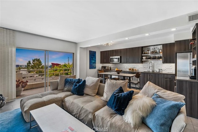 1131 Alta Loma Rd Unit 207, West Hollywood, CA 90069 - living room with recessed lighting, bar area, and light tile patterned flooring