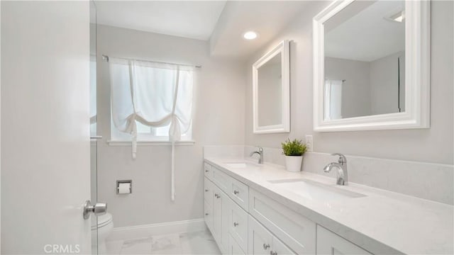 2867 N Shady Glen Ln, Orange, CA 92867 - bathroom with double vanity, marble look tiles, and recessed lighting