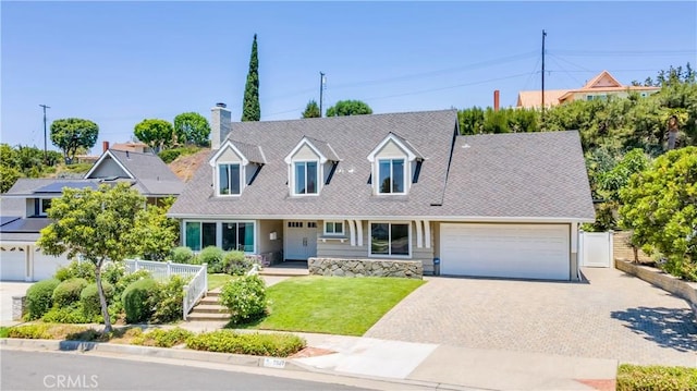 2867 N Shady Glen Ln, Orange, CA 92867 - cape cod home with an attached garage, decorative driveway, and a chimney