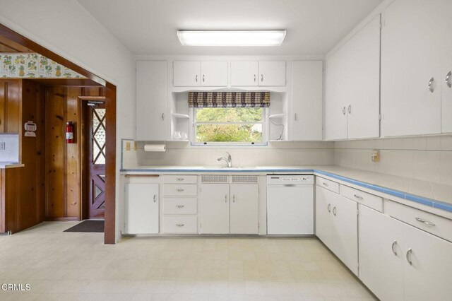 1613 Muir St, Fillmore, CA 93015 - kitchen featuring white dishwasher, open shelves, decorative backsplash, light countertops, and white cabinetry