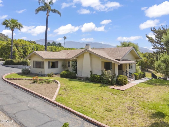 1613 Muir St, Fillmore, CA 93015 - ranch-style home featuring a mountain view, a chimney, a front lawn, and roof with shingles