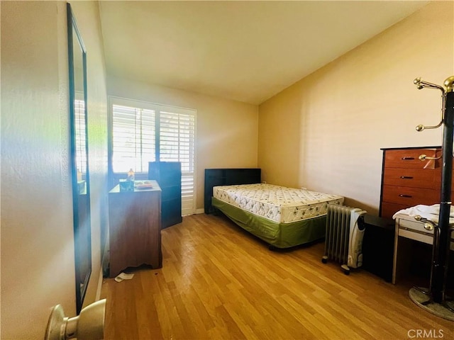 13240 El Dorado Dr Unit 187I, Seal Beach, CA 90740 - bedroom with radiator, wood finished floors, and lofted ceiling