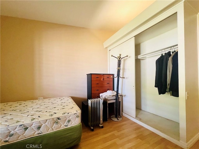 13240 El Dorado Dr Unit 187I, Seal Beach, CA 90740 - bedroom featuring radiator heating unit and wood finished floors
