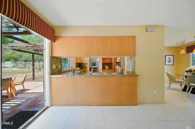 3121 Kingridge Way, Glendale, CA 91206 - kitchen with healthy amount of natural light, light tile patterned floors, stainless steel fridge with ice dispenser, and a peninsula
