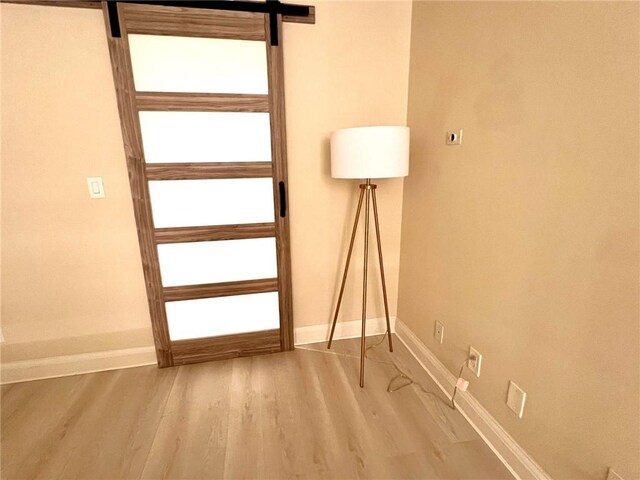 28004 Western Ave S Unit 121, San Pedro, CA 90732 - doorway to outside with baseboards and wood finished floors