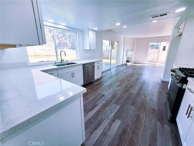 10672 Finch Ave, Rancho Cucamonga, CA 91737 - kitchen featuring stainless steel dishwasher, gas stove, dark wood-style floors, white cabinets, and light stone countertops