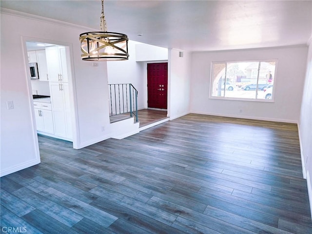 10672 Finch Ave, Rancho Cucamonga, CA 91737 - unfurnished dining area featuring a chandelier, dark wood-type flooring, stairway, and ornamental molding