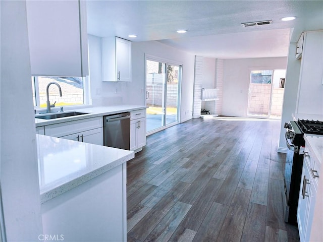 10672 Finch Ave, Rancho Cucamonga, CA 91737 - kitchen with appliances with stainless steel finishes, healthy amount of natural light, dark wood finished floors, white cabinets, and recessed lighting