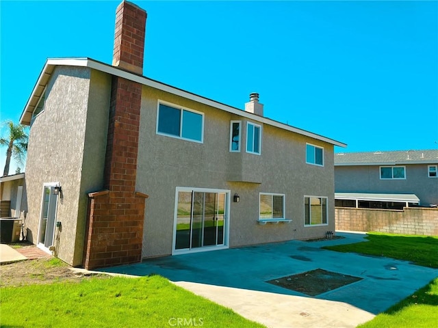 10672 Finch Ave, Rancho Cucamonga, CA 91737 - back of property with a chimney, stucco siding, and a patio area
