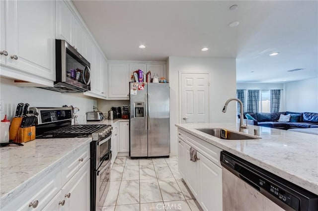 28420 Abbey Ln, Menifee, CA 92585 - kitchen featuring stainless steel appliances, light marble finish floors, white cabinetry, light stone counters, and recessed lighting