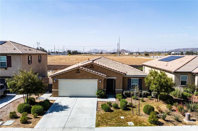 28420 Abbey Ln, Menifee, CA 92585 - view of front of house with stucco siding, a garage, driveway, and a tile roof