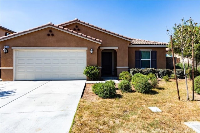 28420 Abbey Ln, Menifee, CA 92585 - view of front facade with stucco siding, driveway, an attached garage, a front yard, and a tile roof
