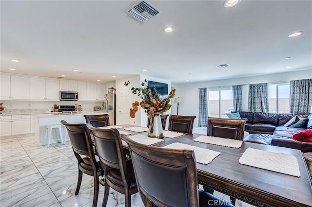 28420 Abbey Ln, Menifee, CA 92585 - dining space with light marble finish floors and recessed lighting