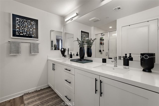 9384 Calm Water Pl, Rancho Cucamonga, CA 91730 - bathroom with double vanity, a shower stall, and wood finished floors