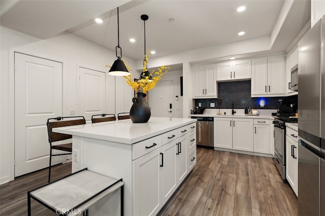 9384 Calm Water Pl, Rancho Cucamonga, CA 91730 - kitchen featuring stainless steel appliances, dark wood finished floors, recessed lighting, light countertops, and white cabinets