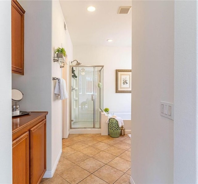 3867 Taconite Rd, San Bernardino, CA 92407 - bathroom with a shower stall, tile patterned flooring, a bath, and recessed lighting