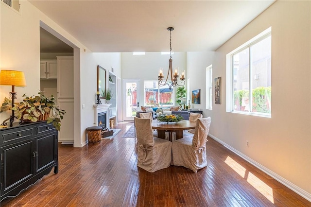 3867 Taconite Rd, San Bernardino, CA 92407 - dining room featuring a chandelier, dark wood-type flooring, and a lit fireplace