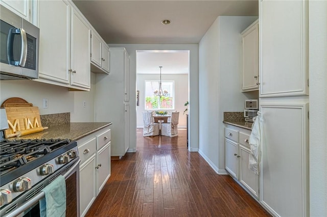 3867 Taconite Rd, San Bernardino, CA 92407 - kitchen with stainless steel appliances, a chandelier, white cabinets, and dark wood-style floors
