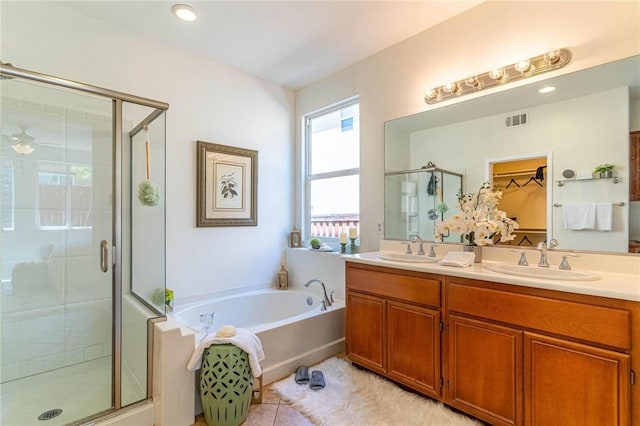 3867 Taconite Rd, San Bernardino, CA 92407 - full bathroom featuring a shower stall, double vanity, a garden tub, and tile patterned flooring