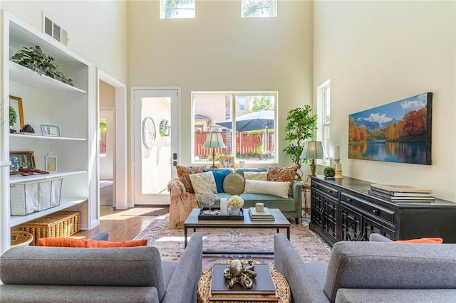 3867 Taconite Rd, San Bernardino, CA 92407 - living room featuring a towering ceiling, wood finished floors, and plenty of natural light