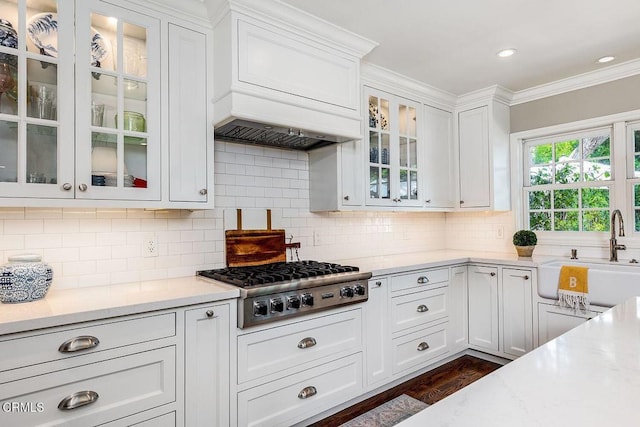 232 Glen Summer Rd, Pasadena, CA 91105 - kitchen featuring stainless steel gas cooktop, white cabinets, crown molding, decorative backsplash, and glass insert cabinets