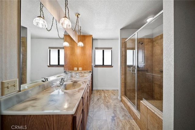 18969 Shoshonee Rd, Apple Valley, CA 92307 - bathroom with a textured ceiling, double vanity, a shower stall, and marble finish flooring
