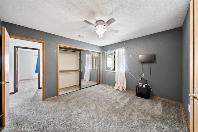 18969 Shoshonee Rd, Apple Valley, CA 92307 - unfurnished bedroom featuring carpet, a textured ceiling, a textured wall, a closet, and a ceiling fan
