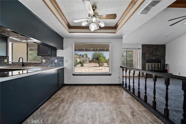 18969 Shoshonee Rd, Apple Valley, CA 92307 - kitchen with a ceiling fan, plenty of natural light, a raised ceiling, light countertops, and ornamental molding