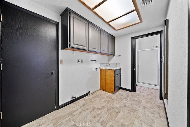 18969 Shoshonee Rd, Apple Valley, CA 92307 - laundry area featuring cabinet space, hookup for an electric dryer, gas dryer hookup, and hookup for a washing machine