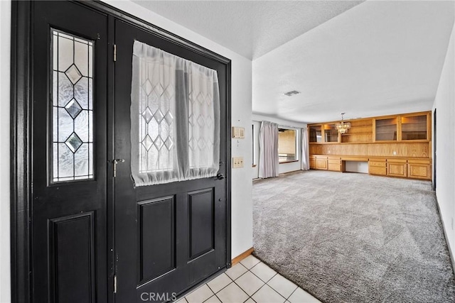 18969 Shoshonee Rd, Apple Valley, CA 92307 - entryway featuring light tile patterned floors and light carpet