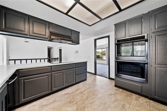 18969 Shoshonee Rd, Apple Valley, CA 92307 - kitchen featuring light countertops, double oven, black electric cooktop, and a peninsula