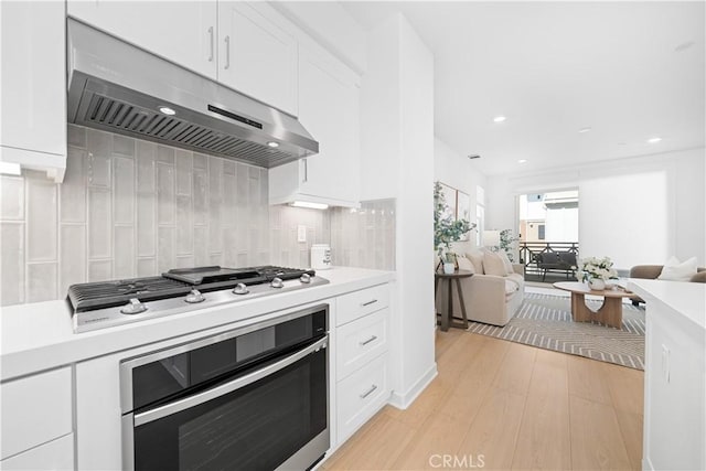 1042 N Anaheim Blvd Unit 2, Anaheim, CA 92801 - kitchen with oven, ventilation hood, stainless steel gas stovetop, light countertops, and white cabinetry