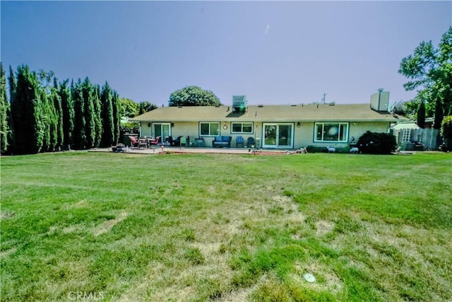 3376 Hackamore Ln, Chico, CA 95973 - back of property with a chimney, a patio area, and a lawn
