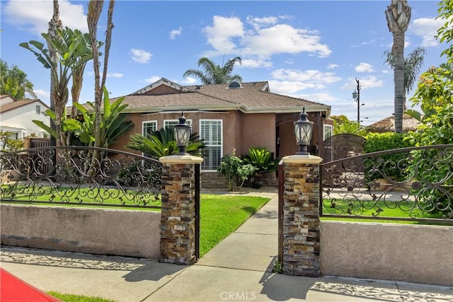 340 N Sunset Ave, West Covina, CA 91790 - view of front facade with stucco siding, a gate, a fenced front yard, and a shingled roof