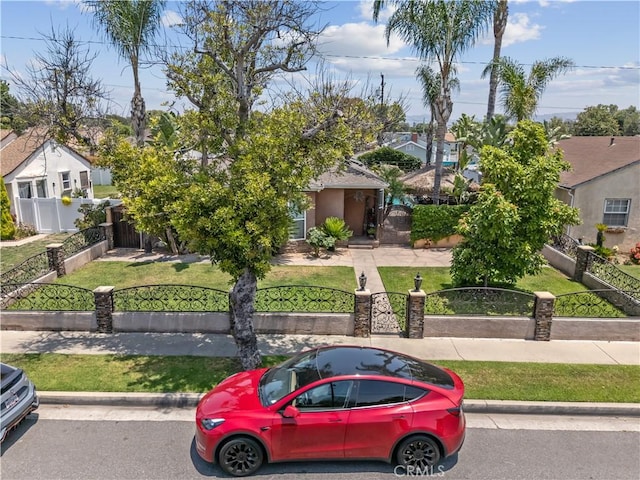 340 N Sunset Ave, West Covina, CA 91790 - view of property hidden behind natural elements featuring a fenced front yard, a gate, and a residential view