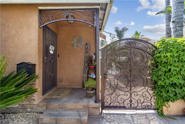 340 N Sunset Ave, West Covina, CA 91790 - entrance to property with a gate and stucco siding