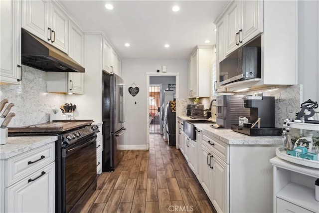 340 N Sunset Ave, West Covina, CA 91790 - kitchen featuring under cabinet range hood, black / electric stove, freestanding refrigerator, dark wood-style floors, and recessed lighting