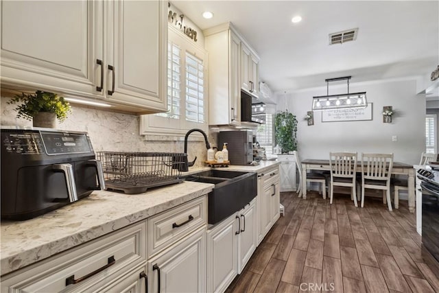 340 N Sunset Ave, West Covina, CA 91790 - kitchen featuring dark wood-style flooring, tasteful backsplash, light stone counters, recessed lighting, and hanging light fixtures