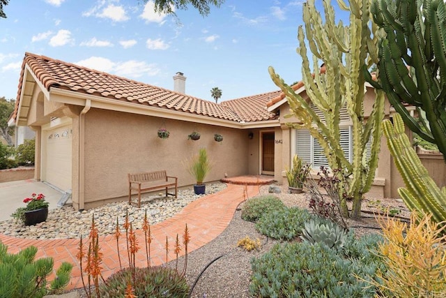 1642 Marbella Dr, Vista, CA 92081 - view of front of home with stucco siding, an attached garage, a tiled roof, and driveway