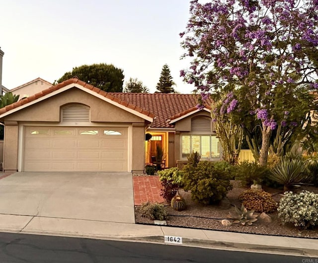 1642 Marbella Dr, Vista, CA 92081 - ranch-style home with a garage, driveway, stucco siding, and a tiled roof