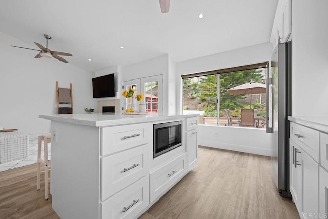 1642 Marbella Dr, Vista, CA 92081 - kitchen with stainless steel appliances, ceiling fan, light wood finished floors, light countertops, and white cabinets