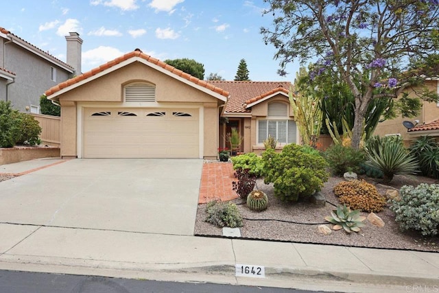1642 Marbella Dr, Vista, CA 92081 - view of front facade with a garage, driveway, a tile roof, and stucco siding