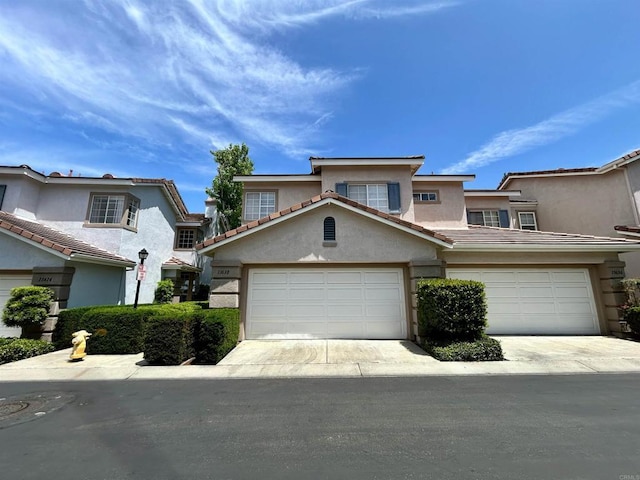 13638 Jadestone Way, San Diego, CA 92130 - view of front facade with stucco siding, a garage, a tiled roof, and concrete driveway