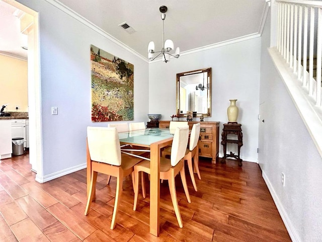 13638 Jadestone Way, San Diego, CA 92130 - dining area with crown molding, a chandelier, and wood finished floors