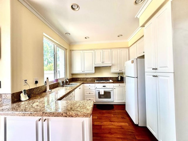 13638 Jadestone Way, San Diego, CA 92130 - kitchen with white appliances, crown molding, a peninsula, white cabinets, and under cabinet range hood