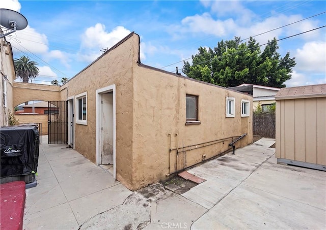 621 S Burris Ave, Compton, CA 90221 - view of property exterior featuring a patio, stucco siding, and a gate