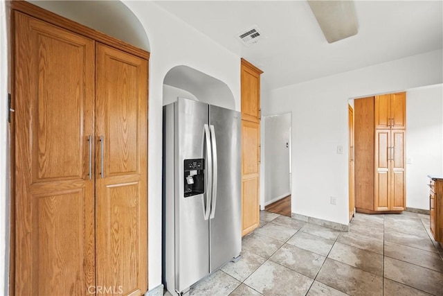 621 S Burris Ave, Compton, CA 90221 - kitchen with stainless steel fridge, brown cabinets, and light tile patterned floors
