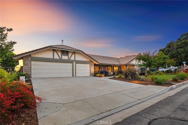 323 N Hacienda Ave, Glendora, CA 91741 - view of front of property with stone siding, an attached garage, stucco siding, concrete driveway, and a tiled roof